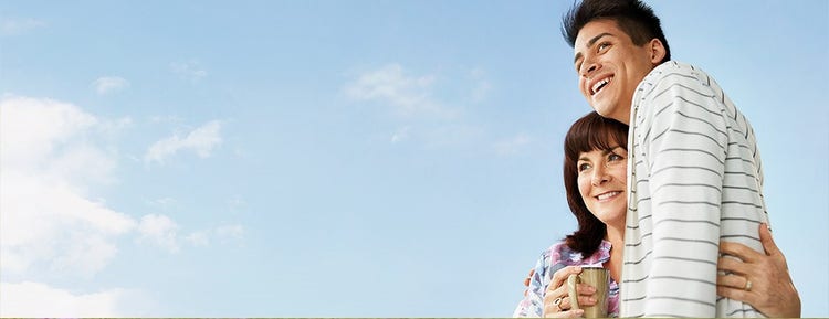 Woman and boy hugging outside