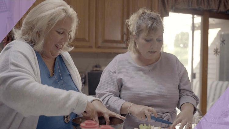 Thumbnail of two women in a kitchen, for the Ibrance (palbociclib) Ambassadors video, Commitment Without Question, featuring Julie, an Ibrance caregiver ambassador